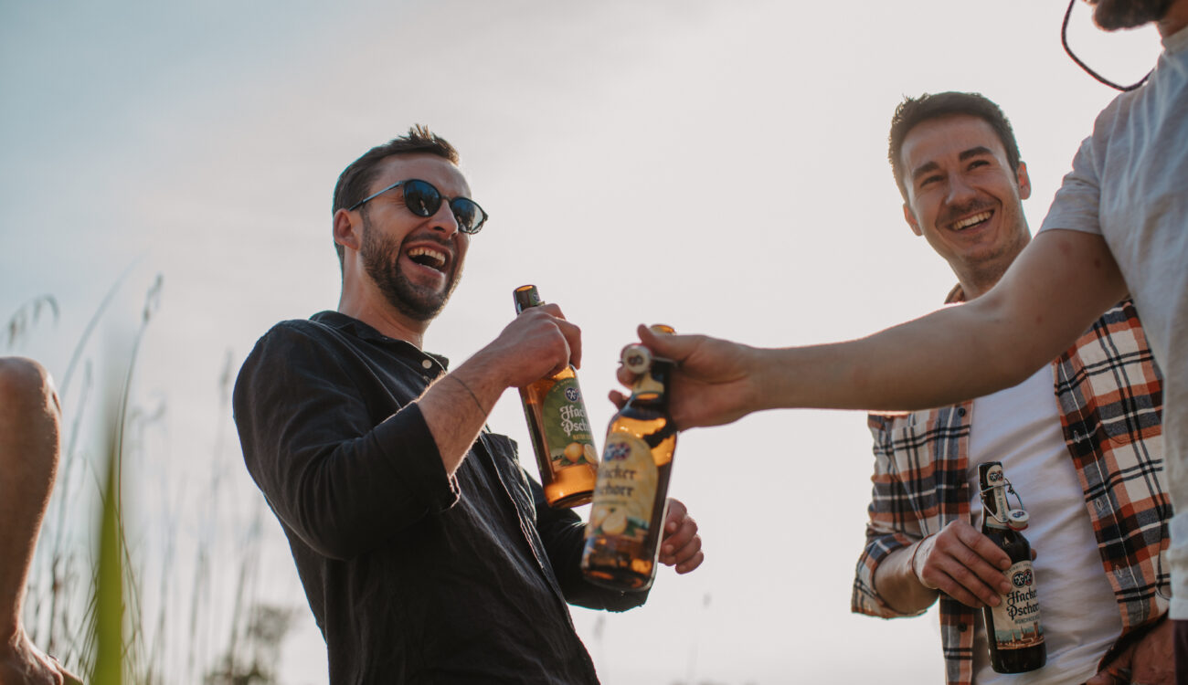 a group of men holding bottles of beer