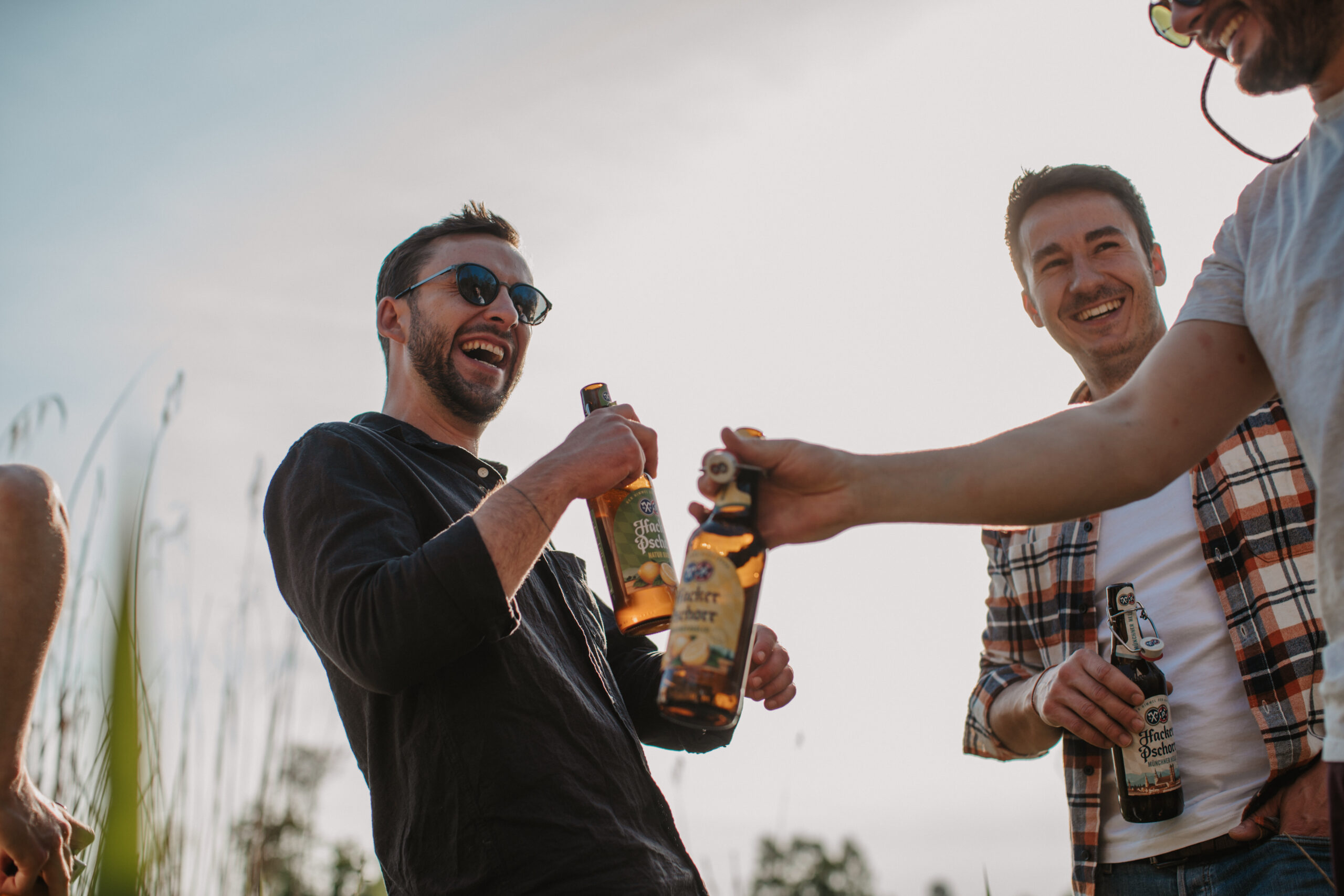 a group of men holding bottles of beer
